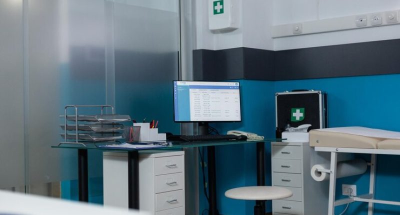 unoccupied-modern-clinic-workspace-with-nobody-it-having-turned-computer-screen-showing-medical-report-medical-room-having-firstaid-kit-contemporary-hospital-furniture-p